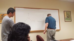 two researchers working at a white board