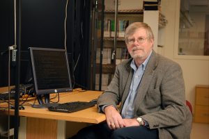 professor sitting at a computer