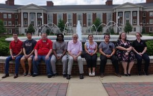 group members and Dr Dixon seated around the Shelby Hall fountain